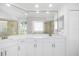 This updated bathroom features double sinks, stylish fixtures, and ample counter space at 11022 Pine Lilly Pl, Lakewood Ranch, FL 34202