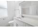 Clean, white bathroom with modern vanity, marble countertop, and sleek fixtures at 11022 Pine Lilly Pl, Lakewood Ranch, FL 34202