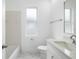 Bright, white bathroom featuring a shower-tub combo, sleek vanity, and white marbled floors at 11022 Pine Lilly Pl, Lakewood Ranch, FL 34202