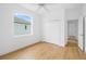 Clean and bright bedroom with wood-look floors, large window, and closet at 11022 Pine Lilly Pl, Lakewood Ranch, FL 34202