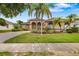Manicured lawn and lush landscaping surround this charming single-Gathering home's exterior at 11022 Pine Lilly Pl, Lakewood Ranch, FL 34202