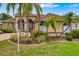 Well-maintained single-Gathering home featuring manicured lawn, lush landscaping and a paved driveway at 11022 Pine Lilly Pl, Lakewood Ranch, FL 34202