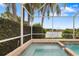 Relaxing hot tub with beautiful lake view and tropical landscaping at 11022 Pine Lilly Pl, Lakewood Ranch, FL 34202