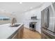 Well-equipped kitchen featuring stainless steel appliances, a spacious island, and white cabinetry at 11022 Pine Lilly Pl, Lakewood Ranch, FL 34202
