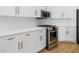Modern kitchen featuring stainless steel appliances, white cabinets, and a sleek gas range at 11022 Pine Lilly Pl, Lakewood Ranch, FL 34202