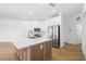 Bright kitchen boasts stainless steel appliances, island with sink, and ample white cabinetry at 11022 Pine Lilly Pl, Lakewood Ranch, FL 34202