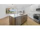 Beautiful kitchen with modern stainless steel appliances, kitchen island, and bright natural light at 11022 Pine Lilly Pl, Lakewood Ranch, FL 34202