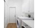 Bright Laundry Room with overhead cabinets and modern washer and dryer at 11022 Pine Lilly Pl, Lakewood Ranch, FL 34202