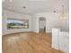 Bright living room offers wood floors, stylish light fixture, and outdoor views at 11022 Pine Lilly Pl, Lakewood Ranch, FL 34202