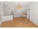 Bright, open living area with tray ceiling, wood-look floors, and decorative chandelier at 11022 Pine Lilly Pl, Lakewood Ranch, FL 34202