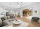 Open-concept living space featuring modern decor, wood floors, and seamless flow to the outdoor patio at 11022 Pine Lilly Pl, Lakewood Ranch, FL 34202
