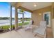 Serene screened patio with comfortable lounge chairs overlooking a tranquil lake at 11022 Pine Lilly Pl, Lakewood Ranch, FL 34202
