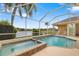 Relaxing screened-in pool and spa with a serene lake view, perfect for outdoor enjoyment at 11022 Pine Lilly Pl, Lakewood Ranch, FL 34202