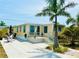 Charming home featuring a well-maintained exterior with a sunny patio and tropical landscaping at 1010 49Th W Ave, Bradenton, FL 34207