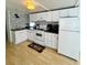 Well-lit kitchen featuring white cabinets, modern appliances, and a stylish backsplash at 1010 49Th W Ave, Bradenton, FL 34207