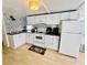 Well-lit kitchen featuring white cabinets, modern appliances, and a stylish backsplash at 1010 49Th W Ave, Bradenton, FL 34207