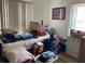 Bedroom with a bed covered in boxes and personal items at 104 22Nd Street E Ct, Bradenton, FL 34208