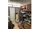 Cluttered garage or storage room with various tools, equipment, and a white door at 104 22Nd Street E Ct, Bradenton, FL 34208