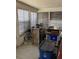 Enclosed porch filled with assorted items, including a bicycle and storage bins at 104 22Nd Street E Ct, Bradenton, FL 34208