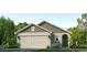 Charming single-Gathering home showcasing a two-car garage, manicured lawn, and stylish architectural details at 10725 Hidden Banks Gln, Parrish, FL 34219