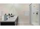 Clean and functional bathroom featuring double sinks, light countertops, and a shower with modern fixtures at 10821 Gentle Current Way, Parrish, FL 34219