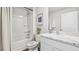 Modern bathroom with marble countertops, bathtub and shower combination, and white cabinetry at 10824 Gentle Current Way, Parrish, FL 34219
