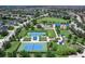 Overhead view of community tennis courts, pool, park, and homes in lush landscaping at 11794 Forest Park Cir, Bradenton, FL 34211