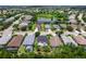 Aerial view of a single-Gathering home with a screened pool in a community near a pond at 11794 Forest Park Cir, Bradenton, FL 34211
