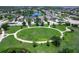 Aerial view of a community park, surrounded by single-Gathering homes and mature trees at 11794 Forest Park Cir, Bradenton, FL 34211
