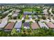 Wide aerial shot of homes in a lush community surrounding a pond at 11794 Forest Park Cir, Bradenton, FL 34211