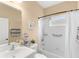 Clean bathroom with white-tiled shower and tub, matching vanity, and tasteful decor at 11794 Forest Park Cir, Bradenton, FL 34211