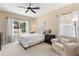 Cozy bedroom features plush carpeting, a comfortable bed, and ample natural light for a relaxing ambiance at 11794 Forest Park Cir, Bradenton, FL 34211