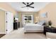 Tranquil bedroom with a ceiling fan, neutral tones, and large windows offering scenic backyard views at 11794 Forest Park Cir, Bradenton, FL 34211