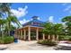 Community pavilion with seating area and picnic tables under a blue metal roof at 11794 Forest Park Cir, Bradenton, FL 34211