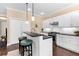 Stylish kitchen with white cabinets, bar seating, granite countertops, and stainless steel appliances offers a welcoming atmosphere at 11794 Forest Park Cir, Bradenton, FL 34211
