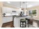 Modern kitchen with white cabinets, stainless steel appliances, and a breakfast bar at 11794 Forest Park Cir, Bradenton, FL 34211