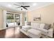 Comfortable living room with a white sectional sofa and access to the screened patio at 11794 Forest Park Cir, Bradenton, FL 34211