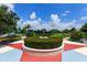 Outdoor park area with green space, seating, and lush tropical landscaping at 11794 Forest Park Cir, Bradenton, FL 34211