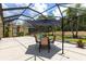 Inviting screened patio with outdoor dining set, perfect for relaxing and entertaining at 11794 Forest Park Cir, Bradenton, FL 34211