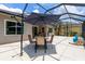 Comfortable screened patio with shaded dining area, ideal for enjoying outdoor meals at 11794 Forest Park Cir, Bradenton, FL 34211
