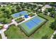 Aerial view of community tennis courts with shade pavilion, landscaping, and green space at 11794 Forest Park Cir, Bradenton, FL 34211