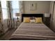 Bedroom featuring soft lighting, a comfortable bed, and elegant floral curtains at 1241 Riverscape St # B, Bradenton, FL 34208