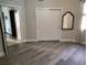 The bedroom features wood-look floors, a walk-in closet, and views of the connected bathroom at 1241 Riverscape St # B, Bradenton, FL 34208