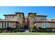 Inviting beige condo building with well-manicured landscaping and a clear blue sky backdrop at 1241 Riverscape St # B, Bradenton, FL 34208