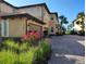 Attractive two-story condo featuring a brick driveway, tropical landscaping, and an attached garage at 1241 Riverscape St # B, Bradenton, FL 34208
