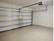 Clean and empty garage with speckled epoxy floor and sectional white garage door at 1241 Riverscape St # B, Bradenton, FL 34208