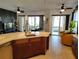 Modern kitchen featuring an island with seating and pendant lights and views of the open living space at 1241 Riverscape St # B, Bradenton, FL 34208