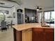 Open-concept kitchen with an island featuring counter seating and a view of the dining and living areas at 1241 Riverscape St # B, Bradenton, FL 34208