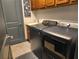 Modern laundry room with front load washer and dryer, sink, and wooden cabinets at 1241 Riverscape St # B, Bradenton, FL 34208