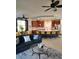 Open-concept living space with large kitchen island, stainless appliances, and modern decor with view of exterior at 1241 Riverscape St # B, Bradenton, FL 34208